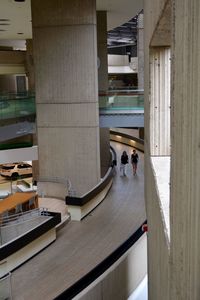 High angle view of people walking in corridor of building