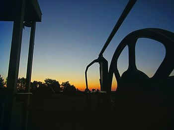 Silhouette landscape against clear sky during sunset