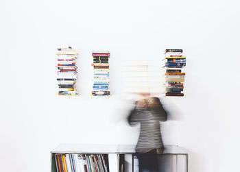 Stack of books on shelf against white background