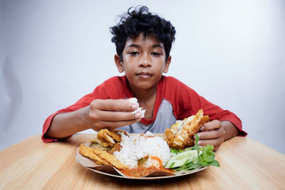 Portrait of young woman eating food