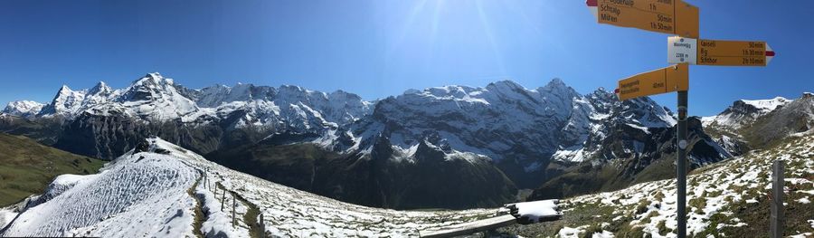 Low angle view of snowcapped mountains against sky