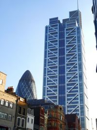 Low angle view of modern building against clear blue sky