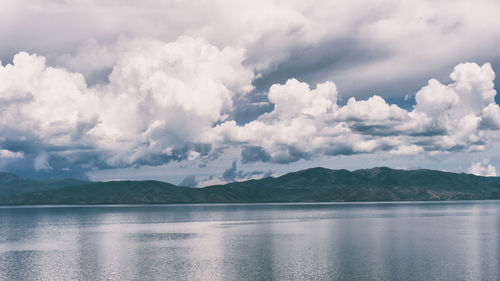 Scenic view of sea and mountains against sky