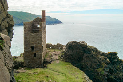 Historic building by sea against sky