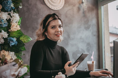 Portrait of young woman using mobile phone