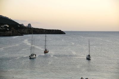 Sailboat sailing on sea against sky
