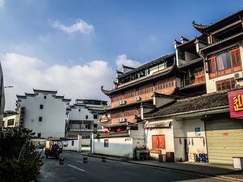 Street amidst buildings in city against sky