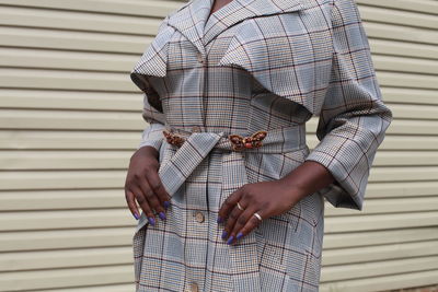 Midsection of woman in formalwear standing outdoors