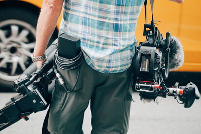 Midsection of camera operator