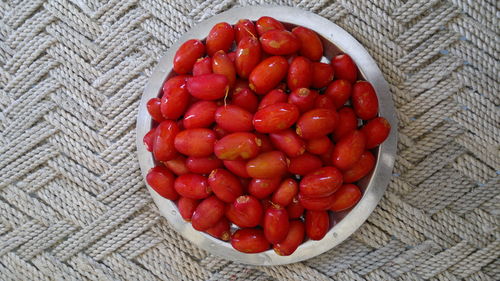 High angle view of red fruits in bowl on table