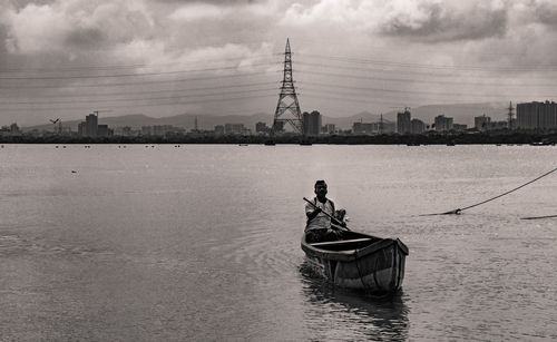 Boats in river with buildings in background