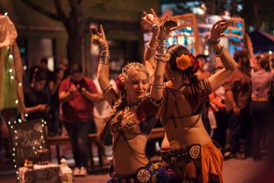 People in traditional clothing standing at night