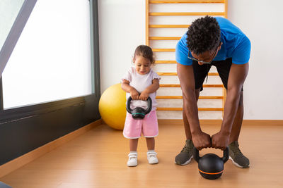 Full length of woman exercising in gym