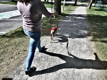 Low section of people walking on road