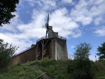 Low angle view of building against cloudy sky