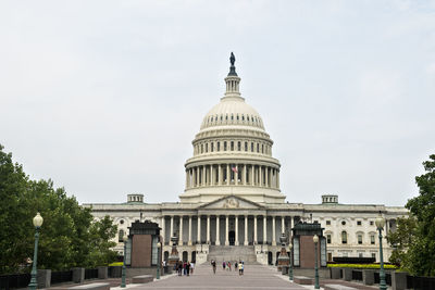 Low angle view of government building against cloudy sky