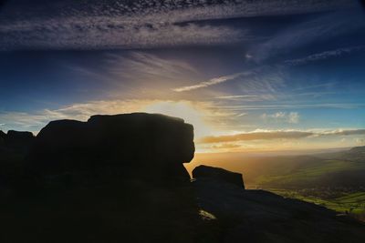 Scenic view of rock formation against sky during sunset