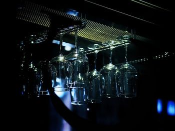 Close-up of illuminated bottles on table