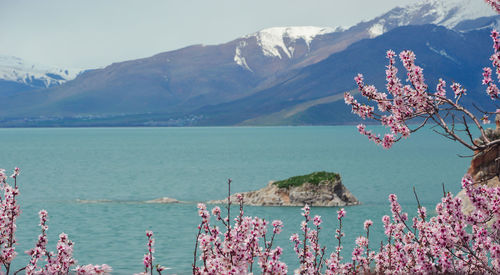 Scenic view of sea and mountains against sky