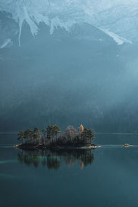 Scenic view of lake by trees against mountain