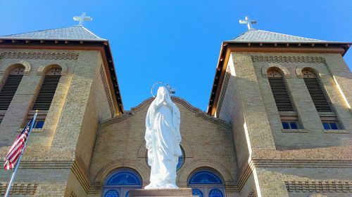 Low angle view of building against blue sky