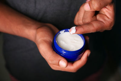 Midsection of man holding coffee