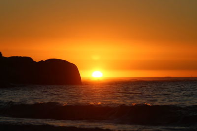 Scenic view of sea against romantic sky at sunset