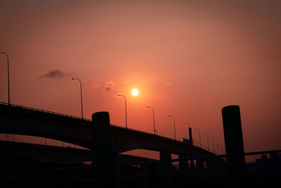 Silhouette bridge against sky during sunset