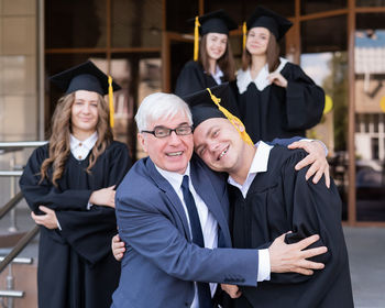 Portrait of students wearing graduation gown