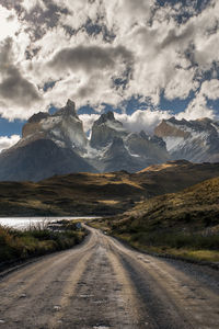 Road amidst mountains against sky