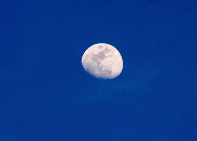 Scenic view of moon against blue sky