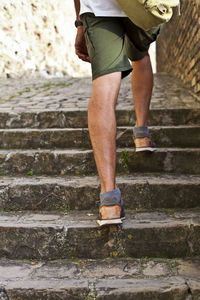 Low section of woman walking on steps