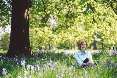 Man standing on grass in forest