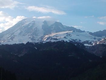 Scenic view of mountains against cloudy sky