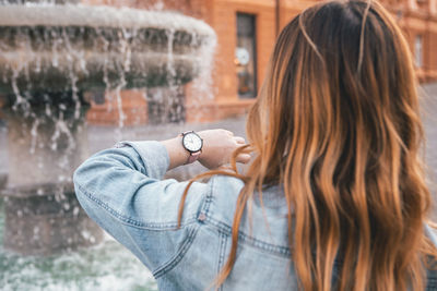 Portrait of woman holding camera in water