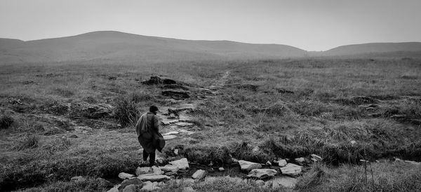 Man on field against sky