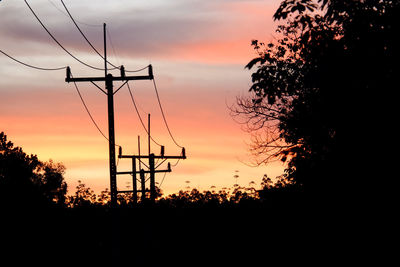 Low angle view of silhouette trees against sky during sunset