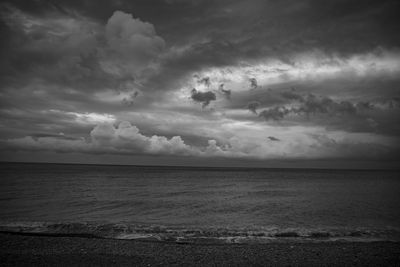 Scenic view of sea against storm clouds