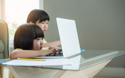 Young woman using laptop at home