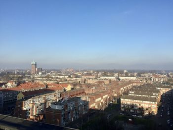 High angle view of townscape against blue sky