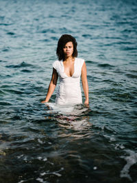 Portrait of woman wearing dress in sea