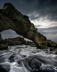 Scenic view of rocks in sea against sky