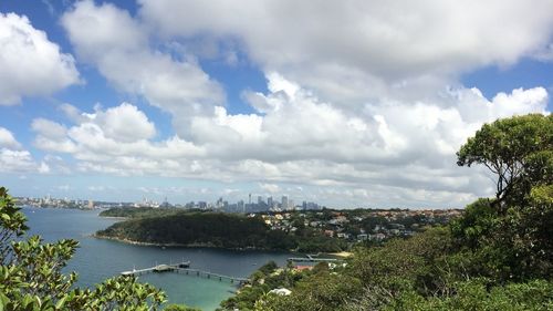 Cityscape against cloudy sky