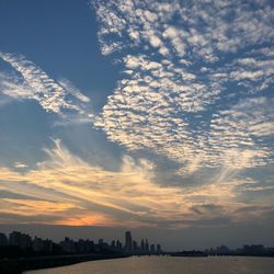 Scenic view of silhouette buildings against sky during sunset