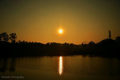 Scenic view of lake at sunset