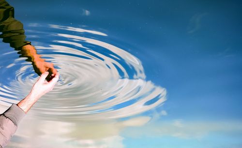 Close-up of hands in rippled water