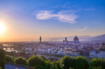 View of buildings in city at sunset