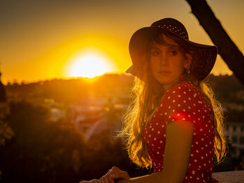 Portrait of woman standing against sky during sunset