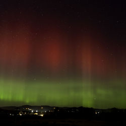 Illuminated cityscape against sky at night