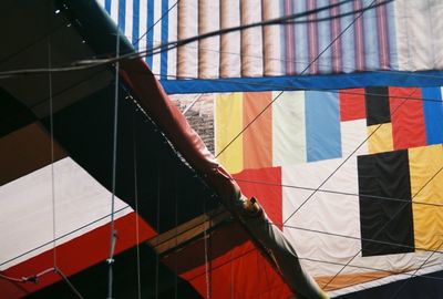 Multi colored flag on tiled floor against building